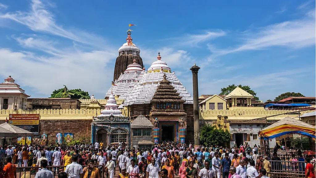 Jagannath Temple Puri with large pilgrim gathering and sacred flags